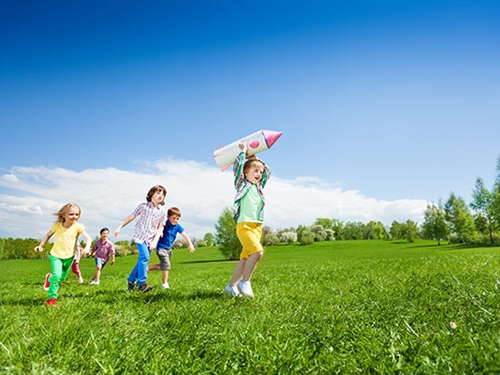 kids playing in the sunshine with a rocket kids playing in the sunshine with a rocket